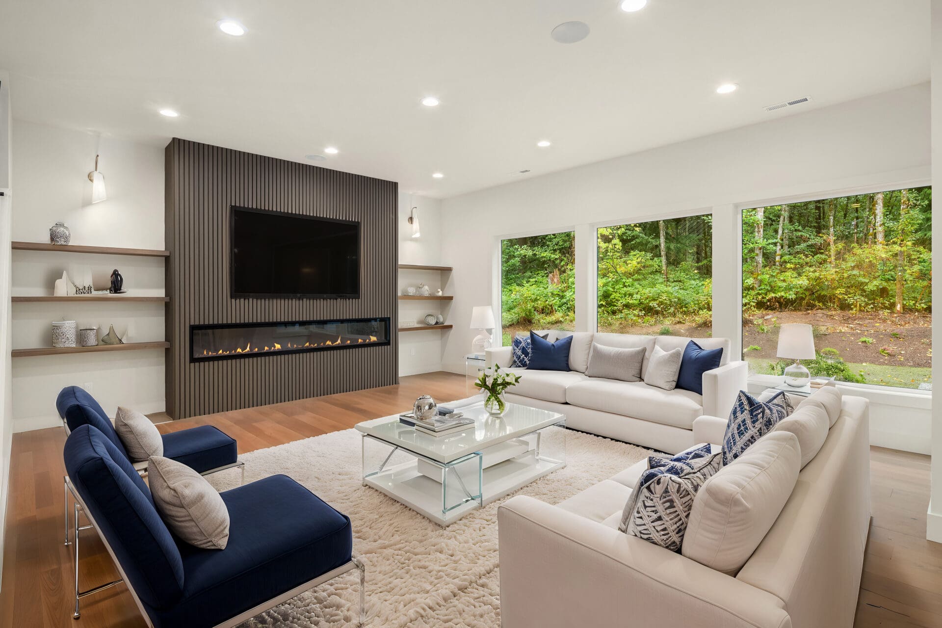 Furnished living room with large windows and hardwood floors