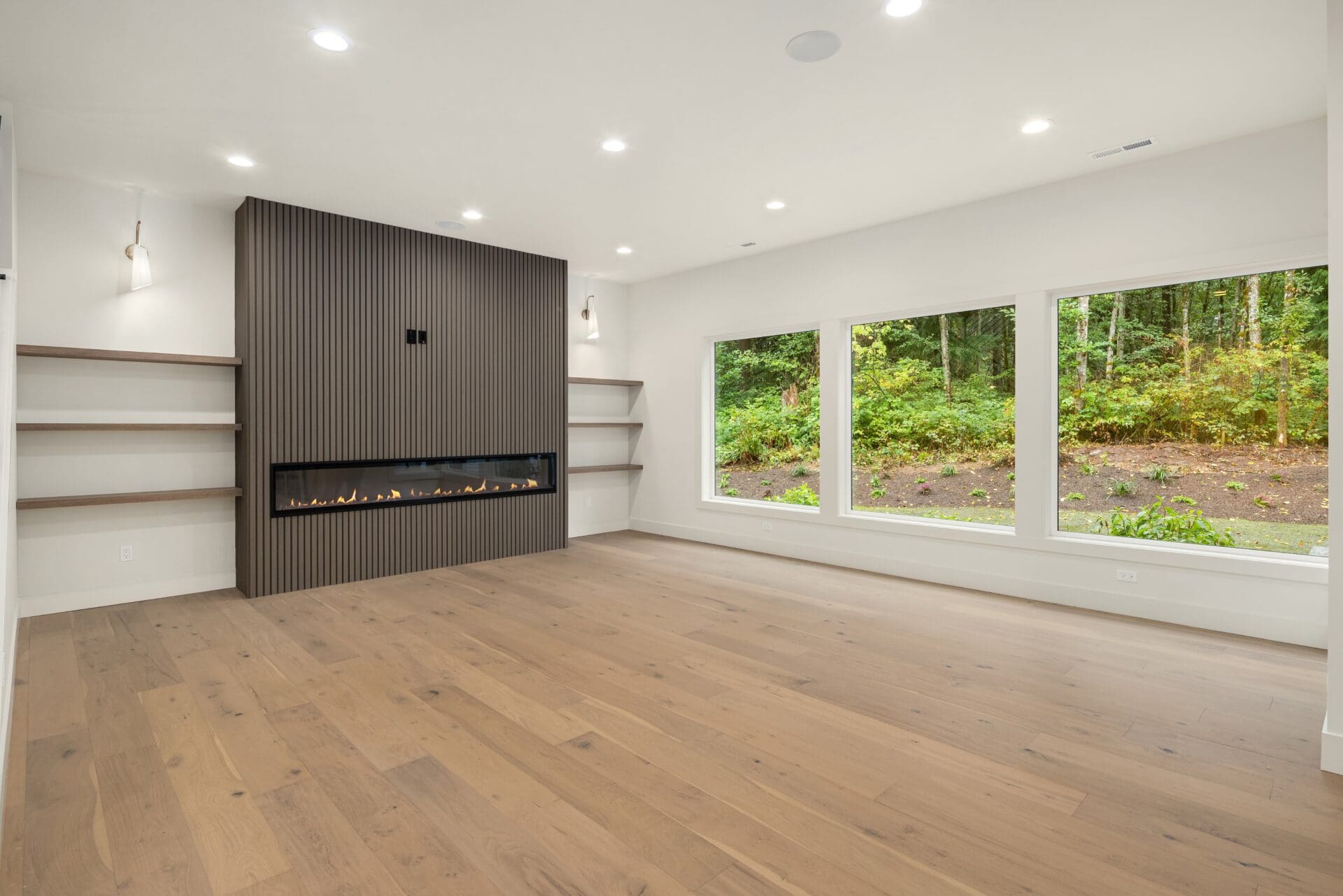 unfurnished livingroom Unfurnished living room with large windows and hardwood floors