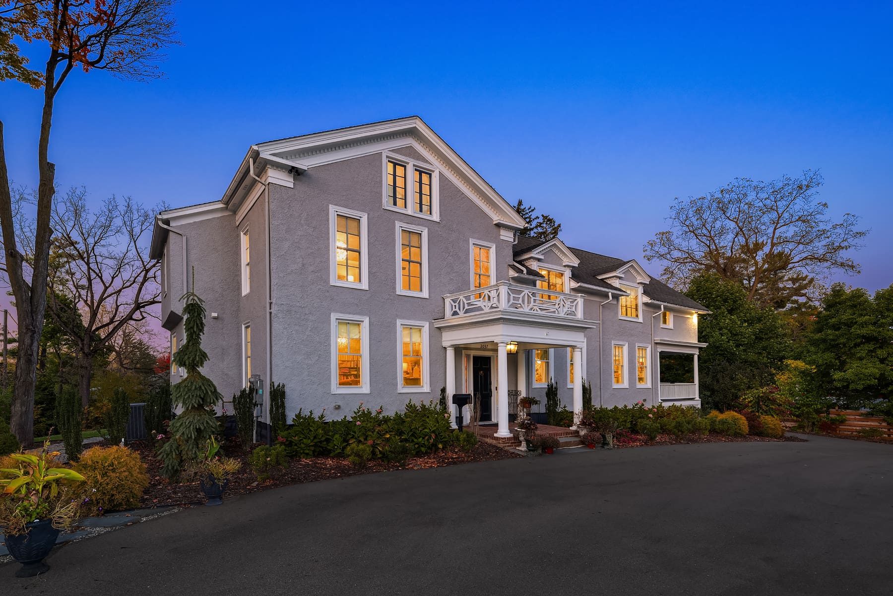 Elegant exterior of a modern home at twilight, showcasing large windows and tasteful landscaping, located in the Pacific Northwest.
