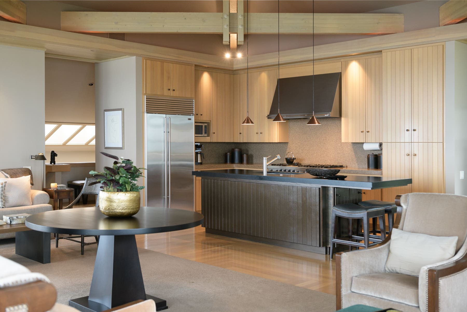 Modern kitchen featuring sleek cabinetry, a central island, and stylish pendant lighting, located in the Pacific Northwest.