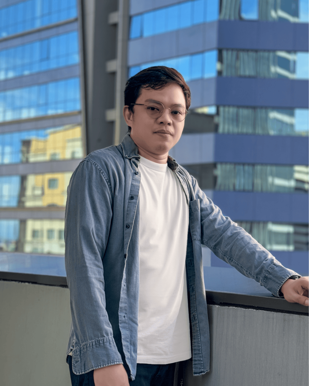 Urban balcony space with a modern design, featuring glass buildings in the background, showcasing a stylish individual in casual attire, located in Seattle.