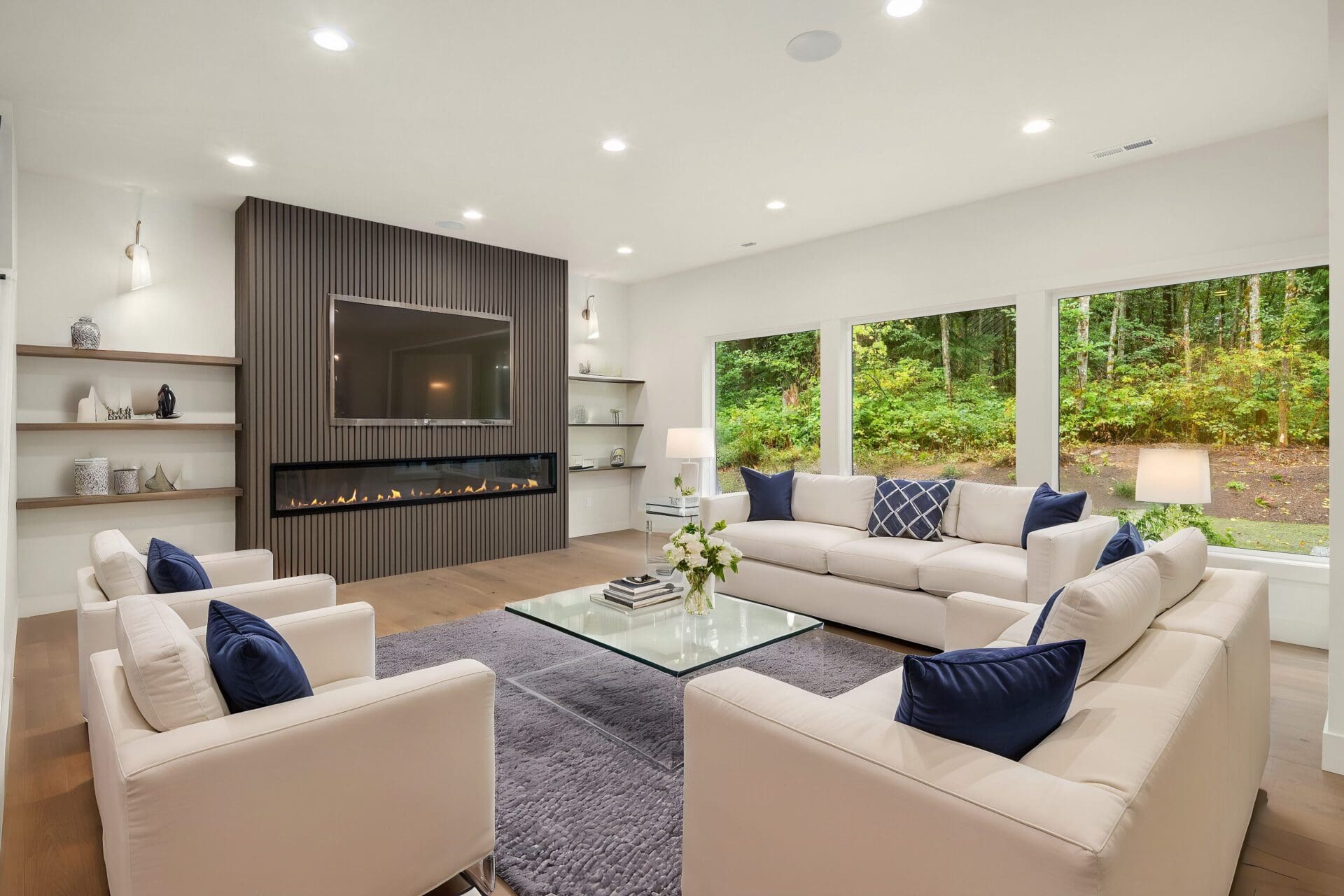 Furnished living room with large windows and hardwood floors