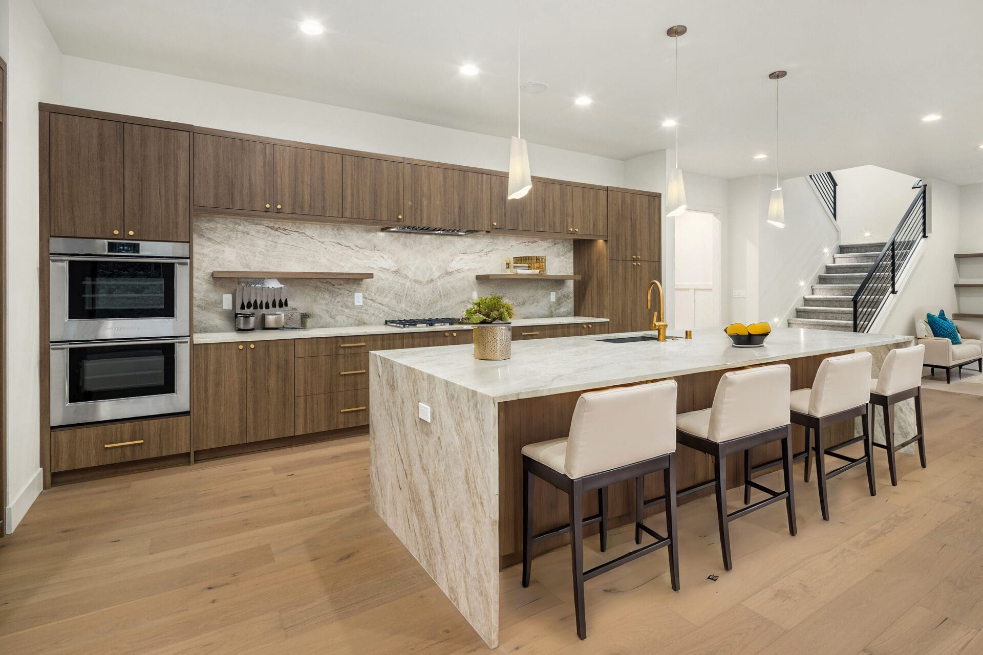 Modern kitchen featuring sleek wooden cabinetry, a spacious marble island, and stainless steel appliances, located in the Pacific Northwest.