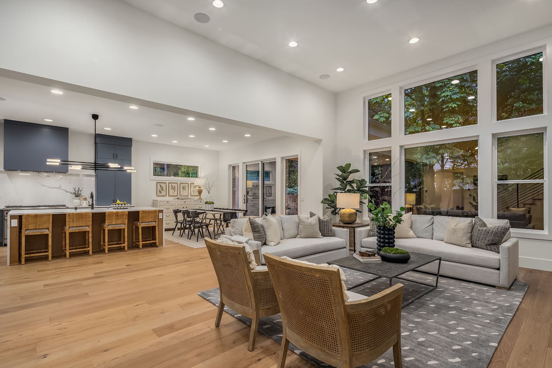 Modern living room with an open layout, featuring elegant furniture and large windows that bring in natural light, located in the Pacific Northwest.