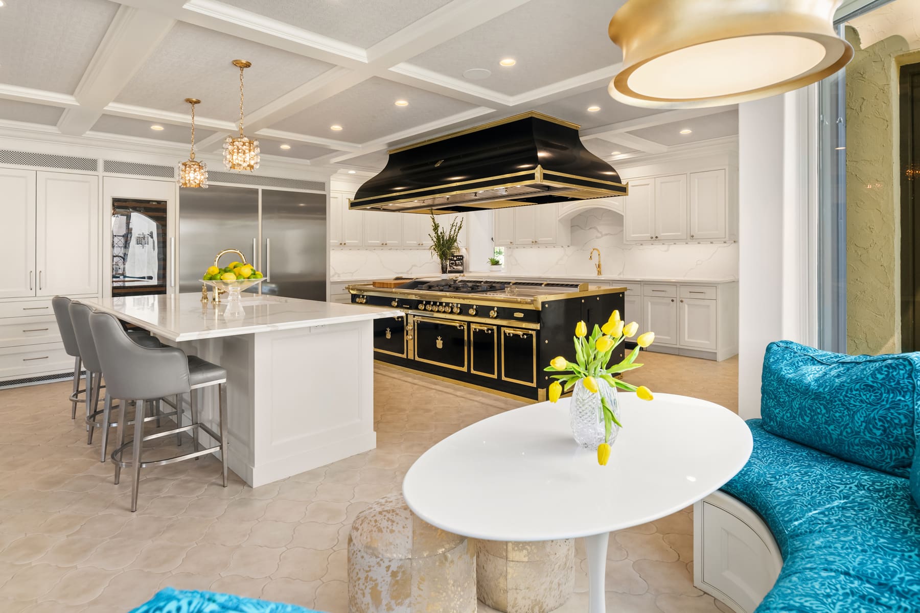 Modern kitchen with elegant black and gold accents, featuring a spacious island, stainless steel appliances, and a cozy breakfast nook, located in the Pacific Northwest.