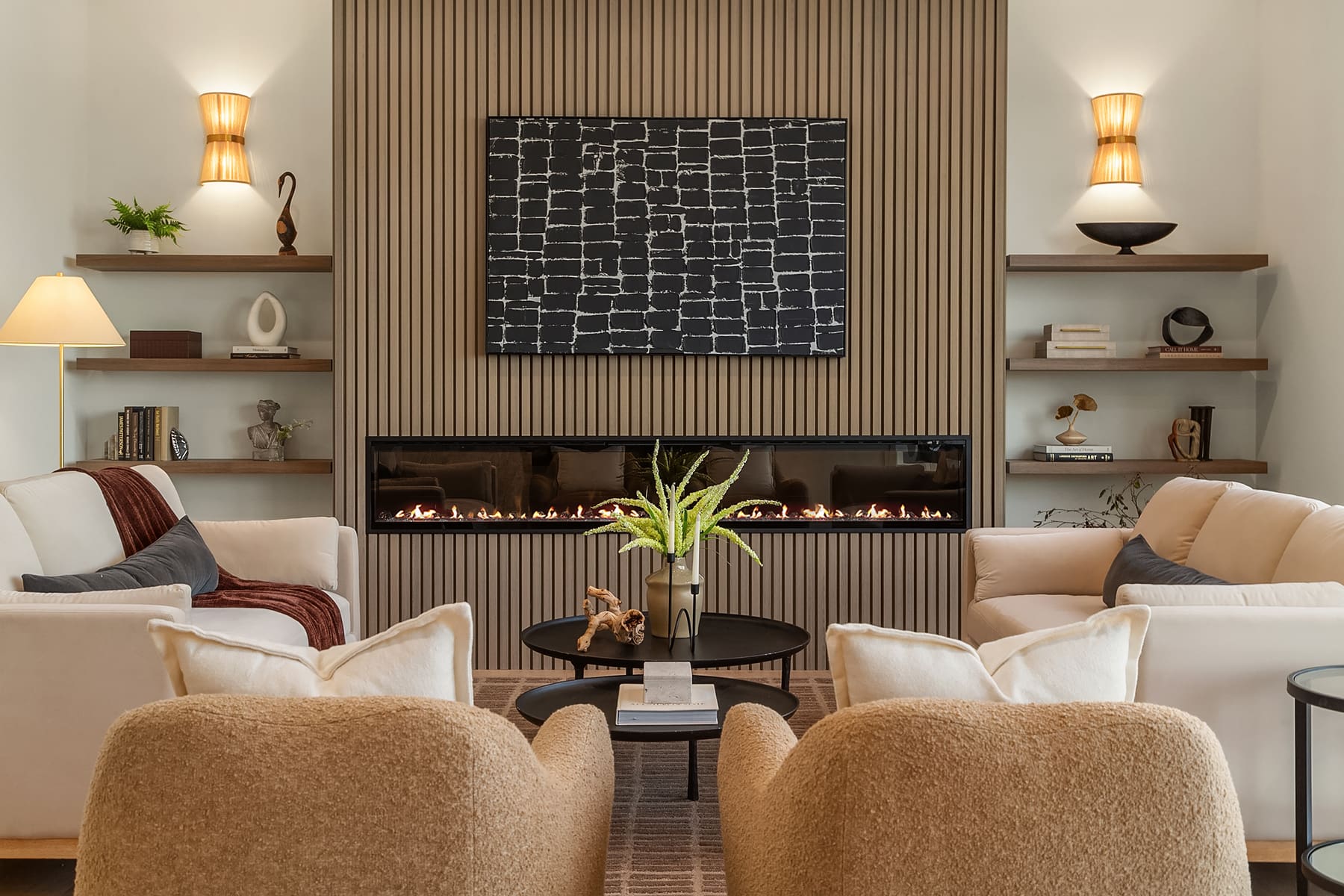 Modern living room featuring a sleek linear fireplace, elegant wall art, and cozy seating arrangements in a neutral color palette. The space exudes a warm and inviting atmosphere, ideal for relaxation. Located in the Pacific Northwest.